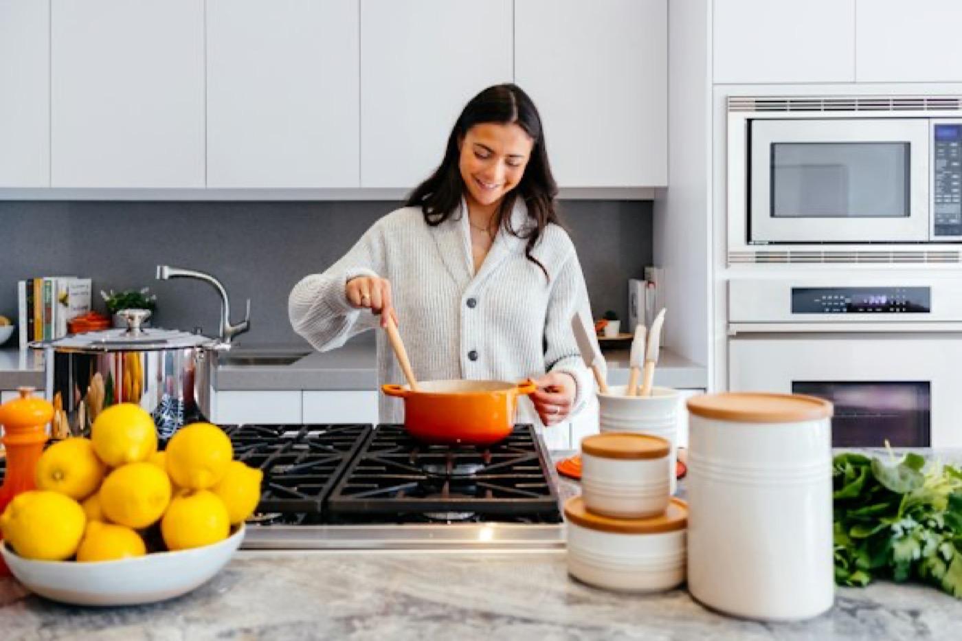 A warm Indian kitchen counter with brass, herbs and everyday cooking